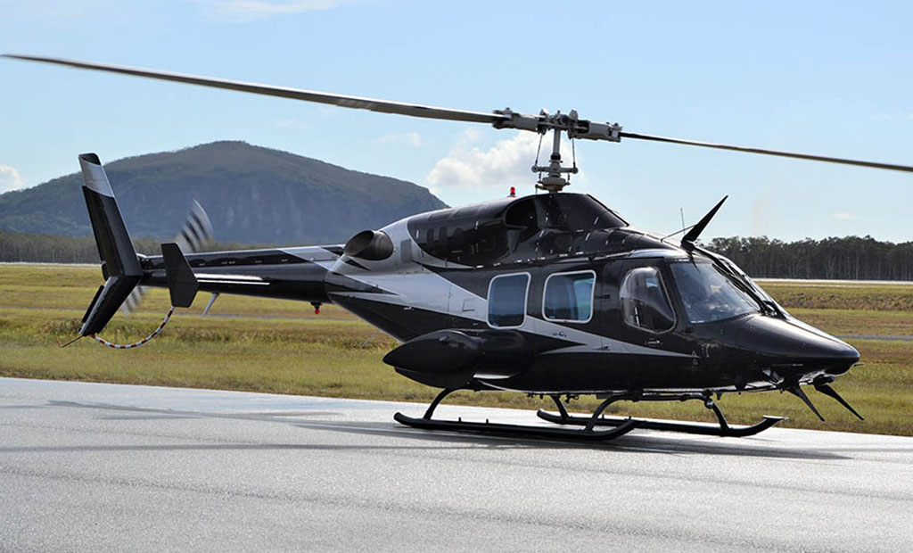 Bell 222 in front of Mount Coolum