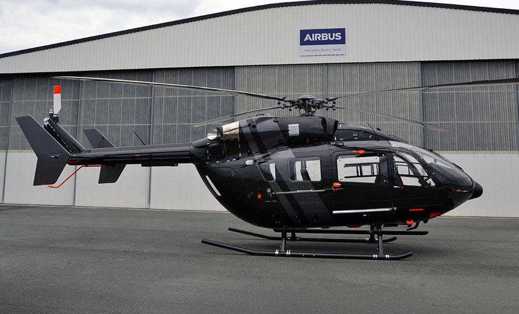 Airbus EC145 Helicopter in front of Pacific Crown Helicopters hangar