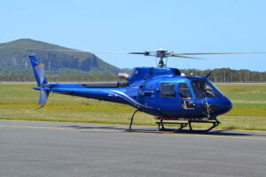 Airbus H125 in front of Mount Coolum, Sunshine Coast, Queensland