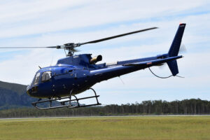 Airbus H125 flying in front of Mount Coolum, Sunshine Coast, Queensland