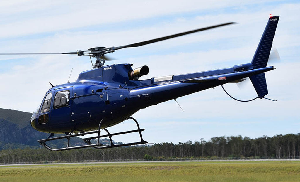 Airbus H125 flying in front of Mount Coolum, Sunshine Coast, Queensland
