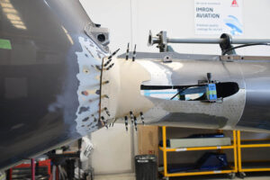 Close-ups of the EC130 B4 helicopter’s tail boom undergoing Level D repair