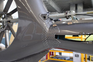 Close-ups of the EC130 B4 helicopter’s tail boom undergoing Level D repair